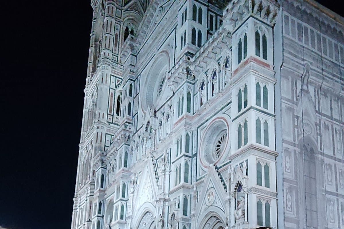 The marble facade of Florence Cathedral lit at night