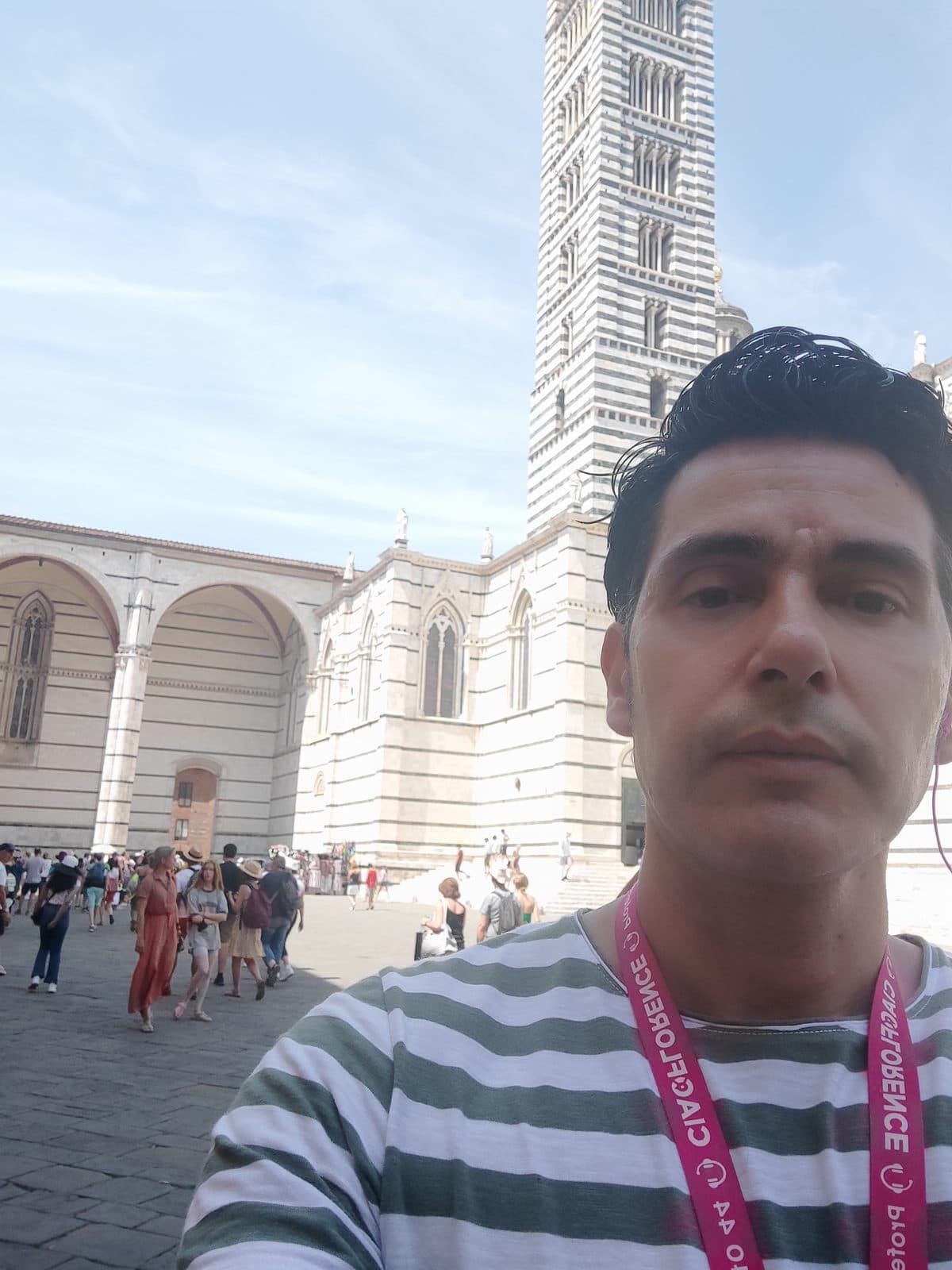 The striped marble campanile of Siena Cathedral seen from below