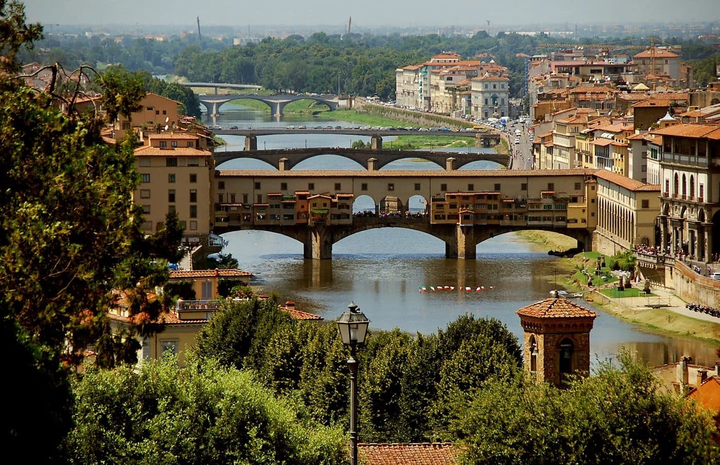 The Ponte Vecchio and its shops seen along the Arno river in Florence